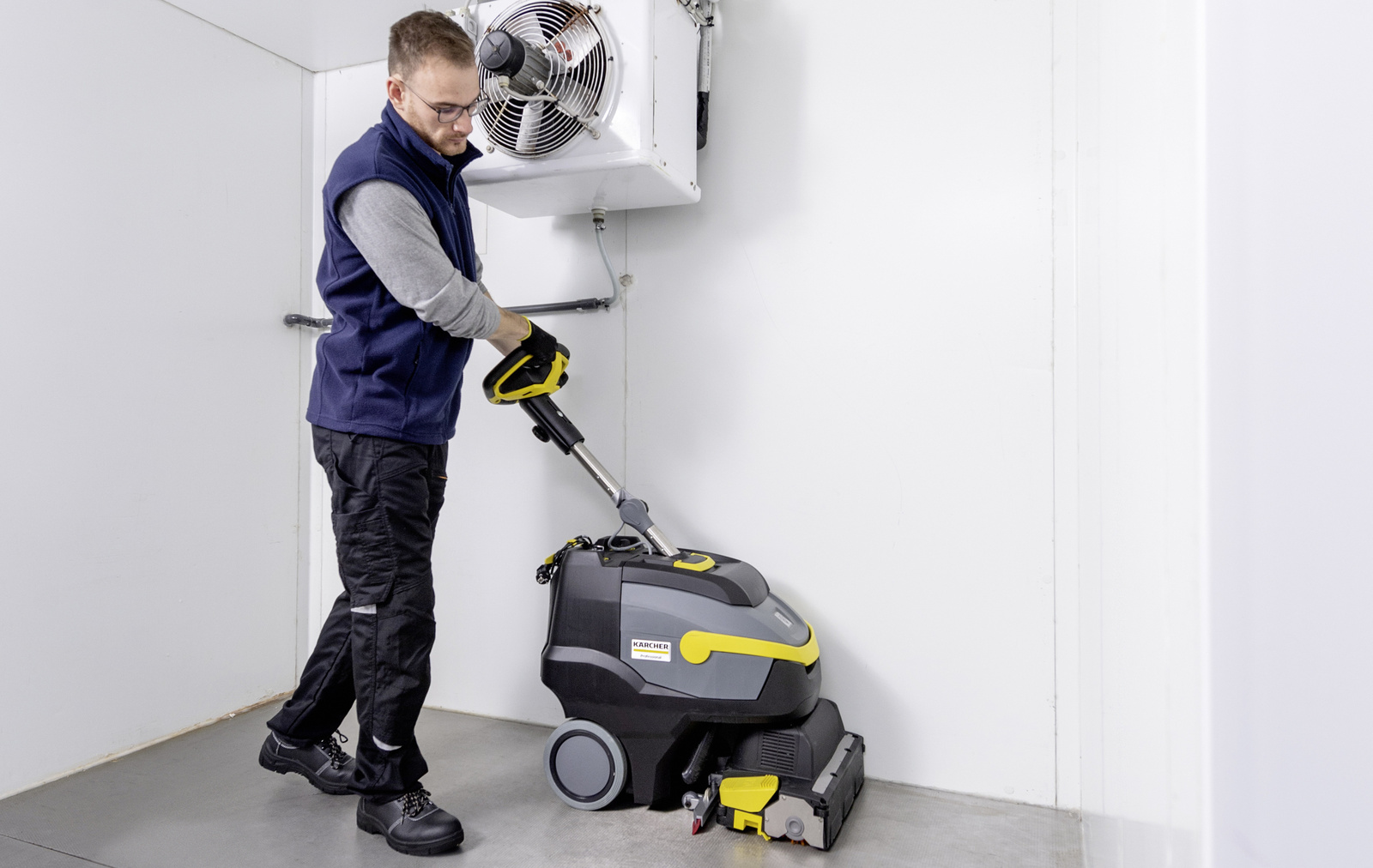 Scrubber dryer in use A person operating a scrubber dryer from Kärcher