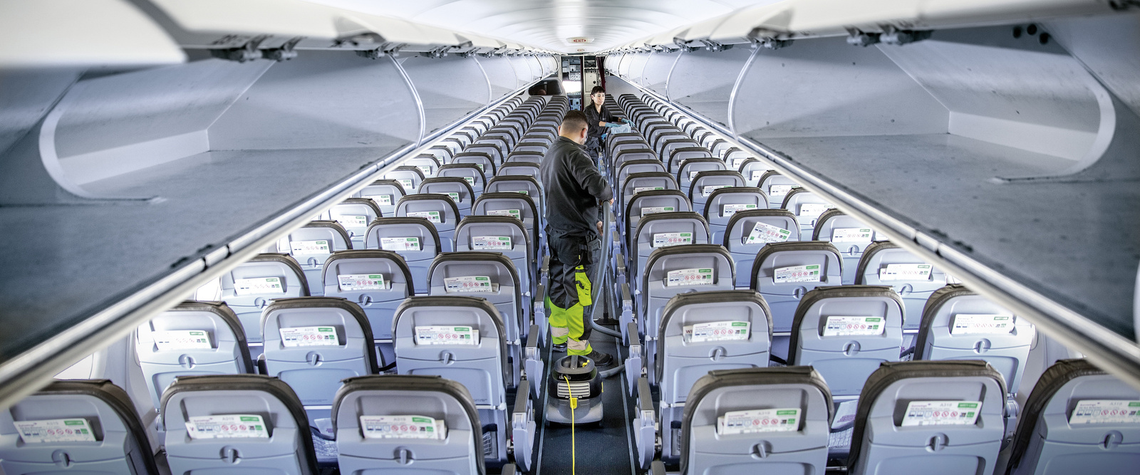 Transport cleaning Two people cleaning the interior of an airplane