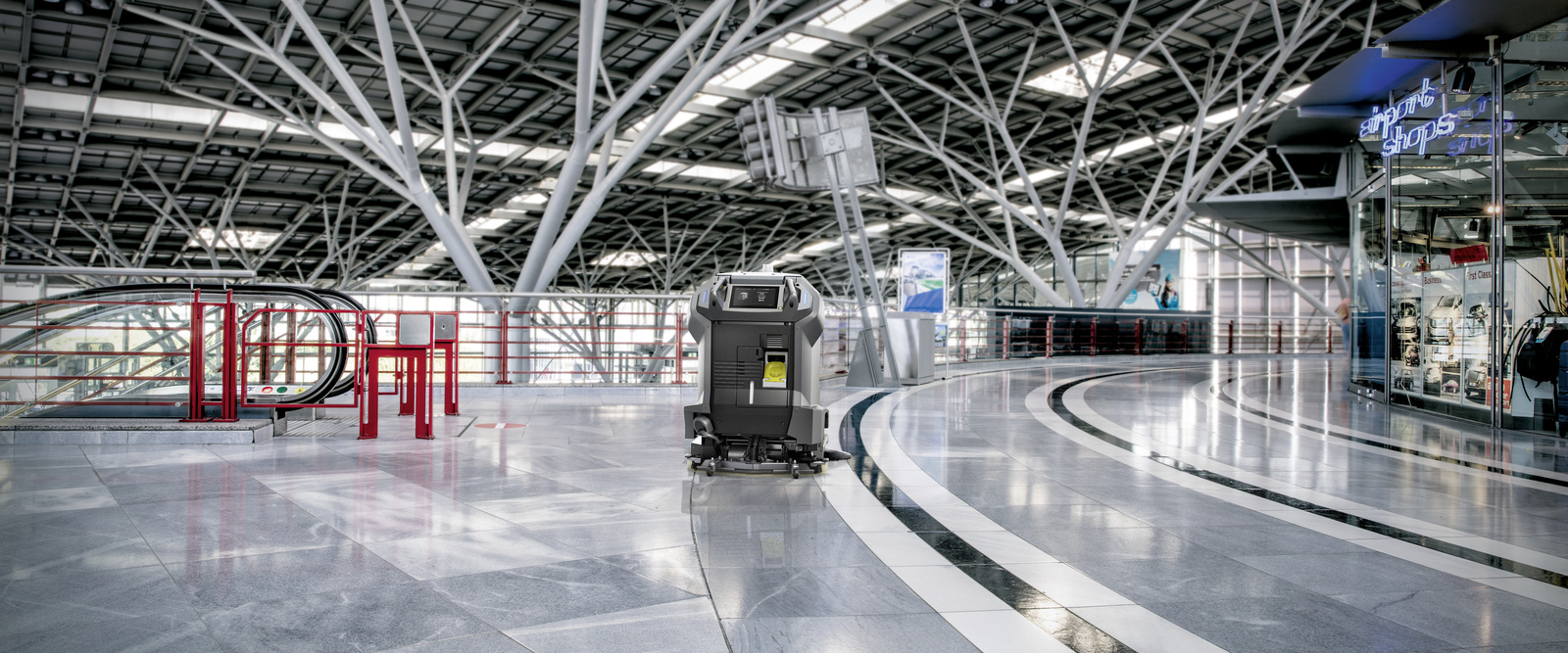 Vacuum robot at the gate A robot cleans the airport area