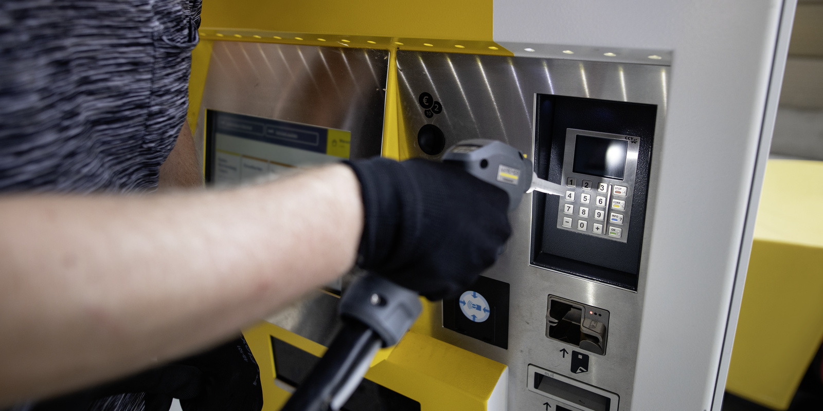 Cleaning ticket machine A person cleans a ticket machine with a dry ice blaster
