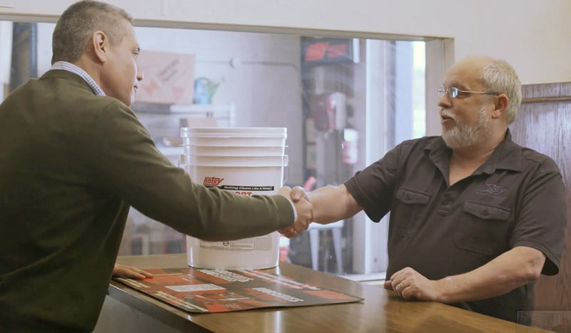 A Hotsy dealer shakes hands with a customer