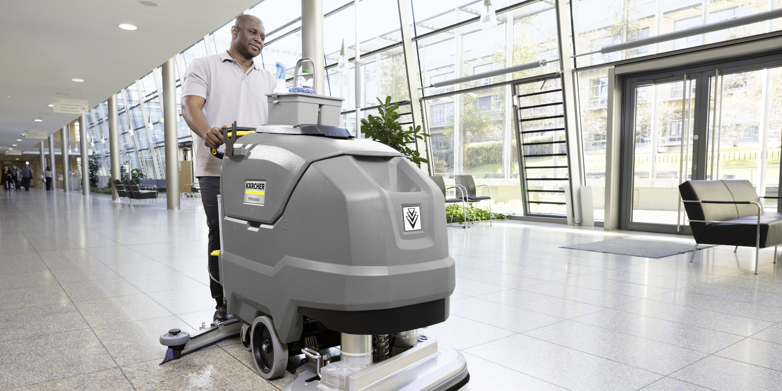 Scrubber dryer A person is operating a scrubber dryer in the entrance area