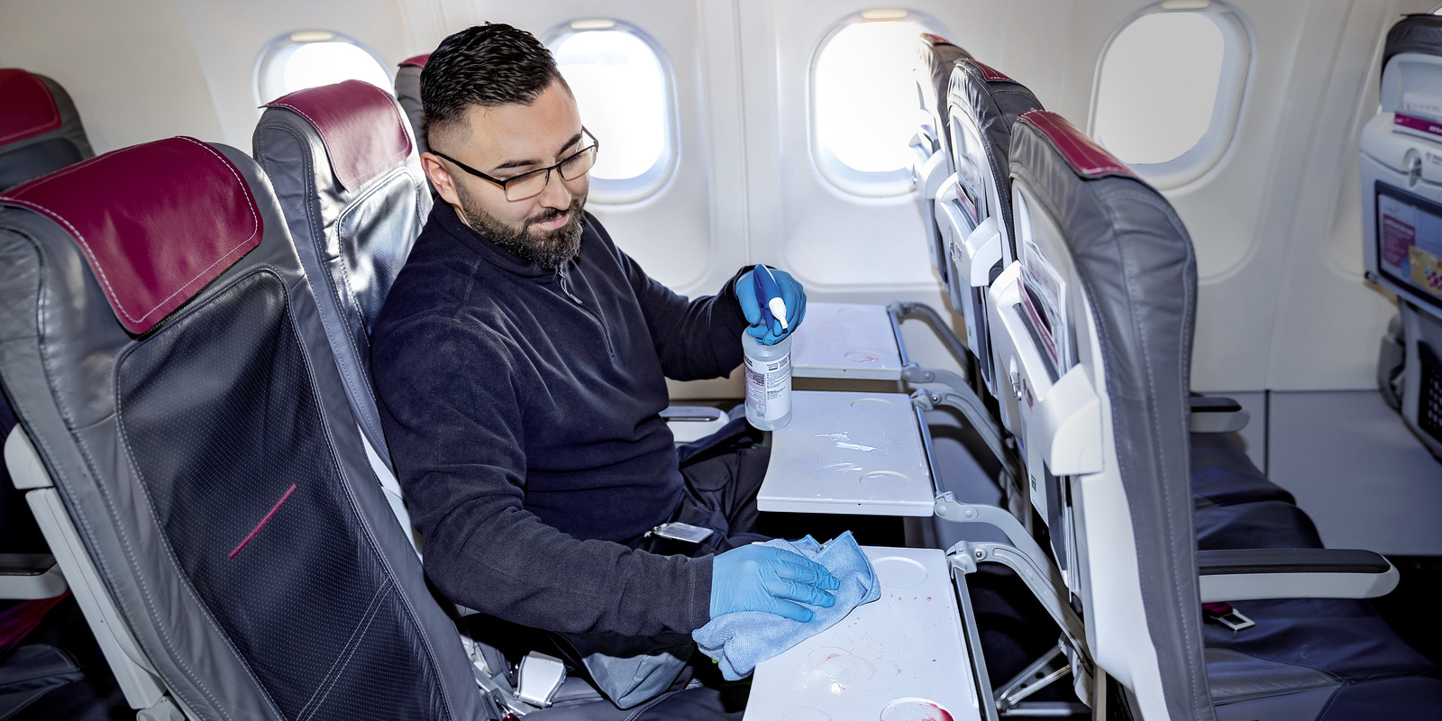 Cleaning in the seating area A person cleaning the seating area with a microfiber cloth