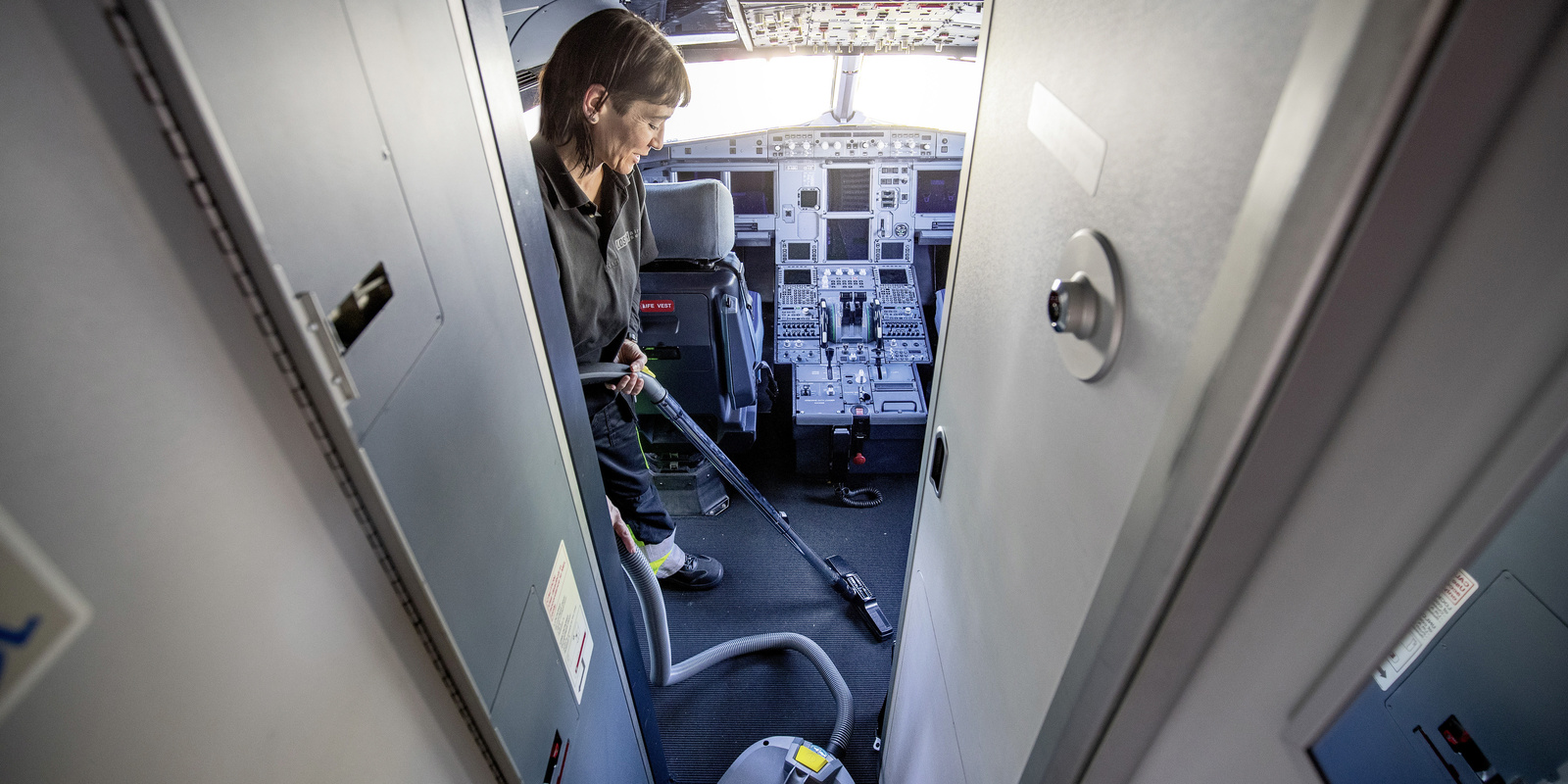 Dry vacuum cleaner in use A person cleaning the cockpit of an airplane with a Kärcher dry vacuum cleaner