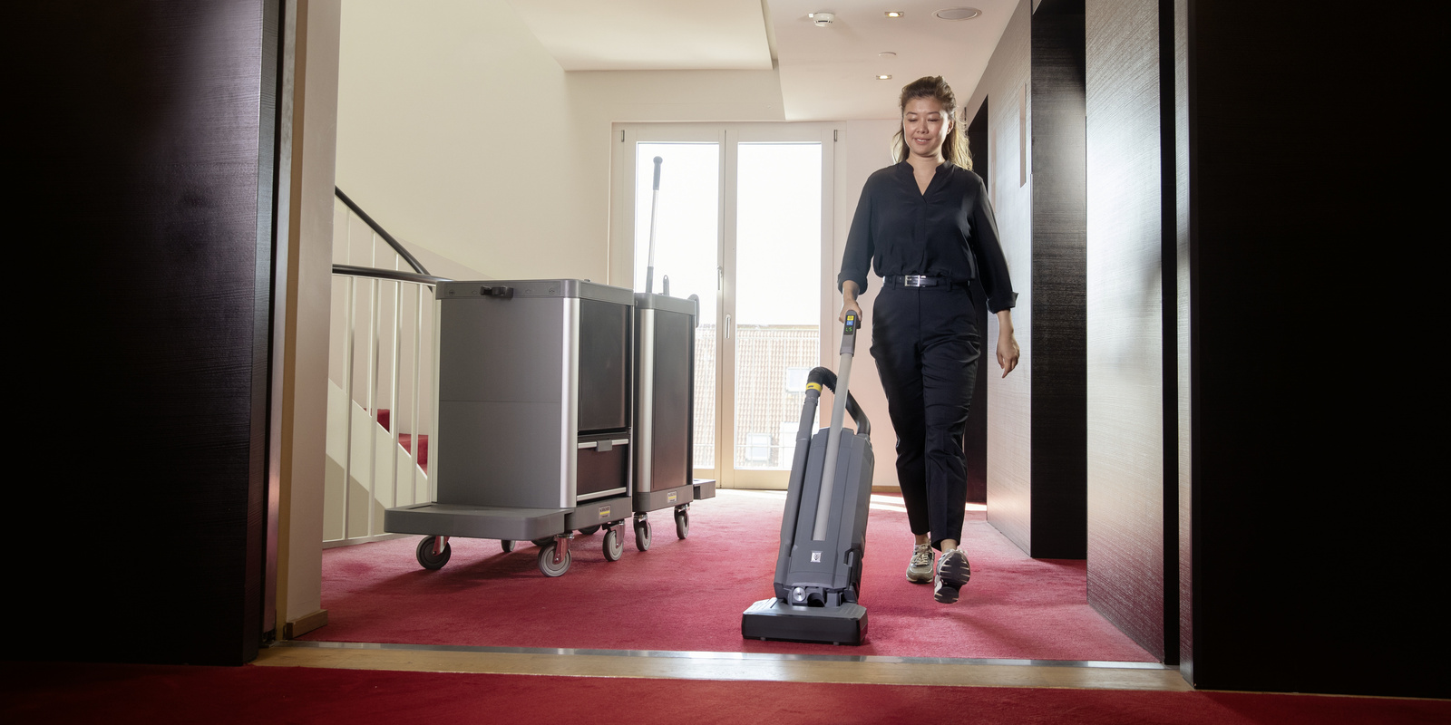 Carpet cleaning with the carpet brush vacuum cleaner A person operating the Kärcher carpet brush vacuum cleaner