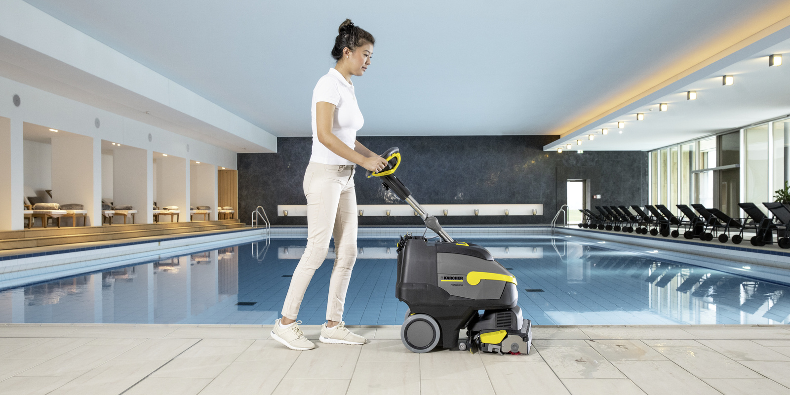 Scrubber dryer in spa area A person cleaning the spa area with a scrubber dryer