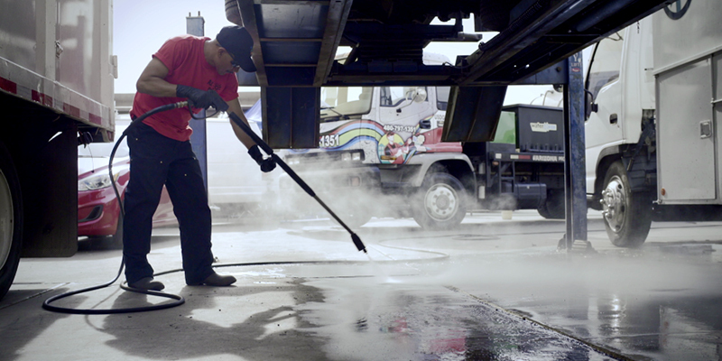 Speed and Efficiency A worker pressure washes in a trucking facility