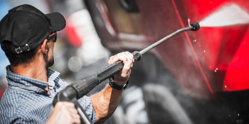 Safe to Use a man pressure washes a big rig