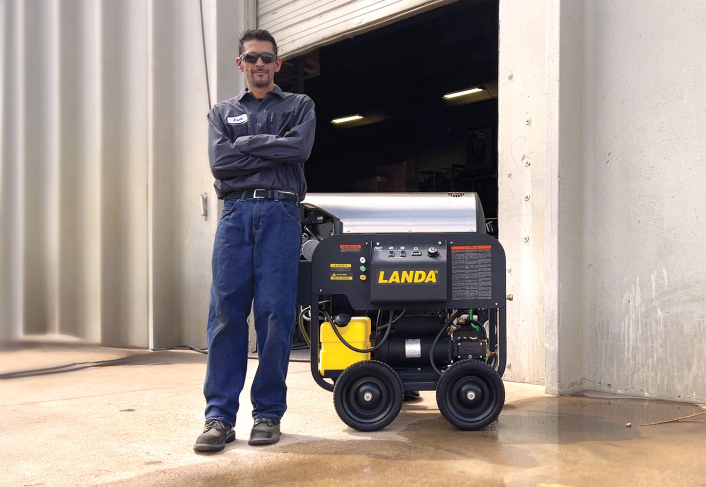 Request a local quote A Landa dealer stands next to a Landa pressure washer