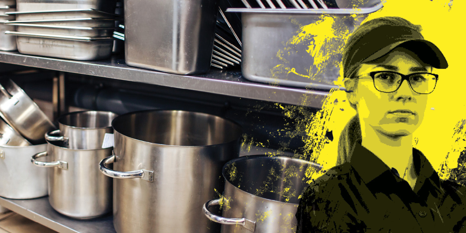 Restaurant & Catering restaurant & catering industry worker next to a commercial kitchen pots and pans