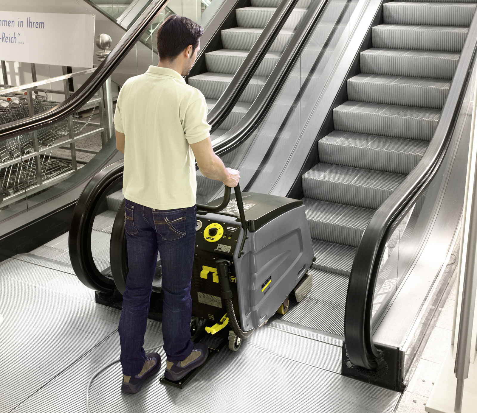 Escalator cleaner in use A man cleaning an escalator with an escalator cleaner.