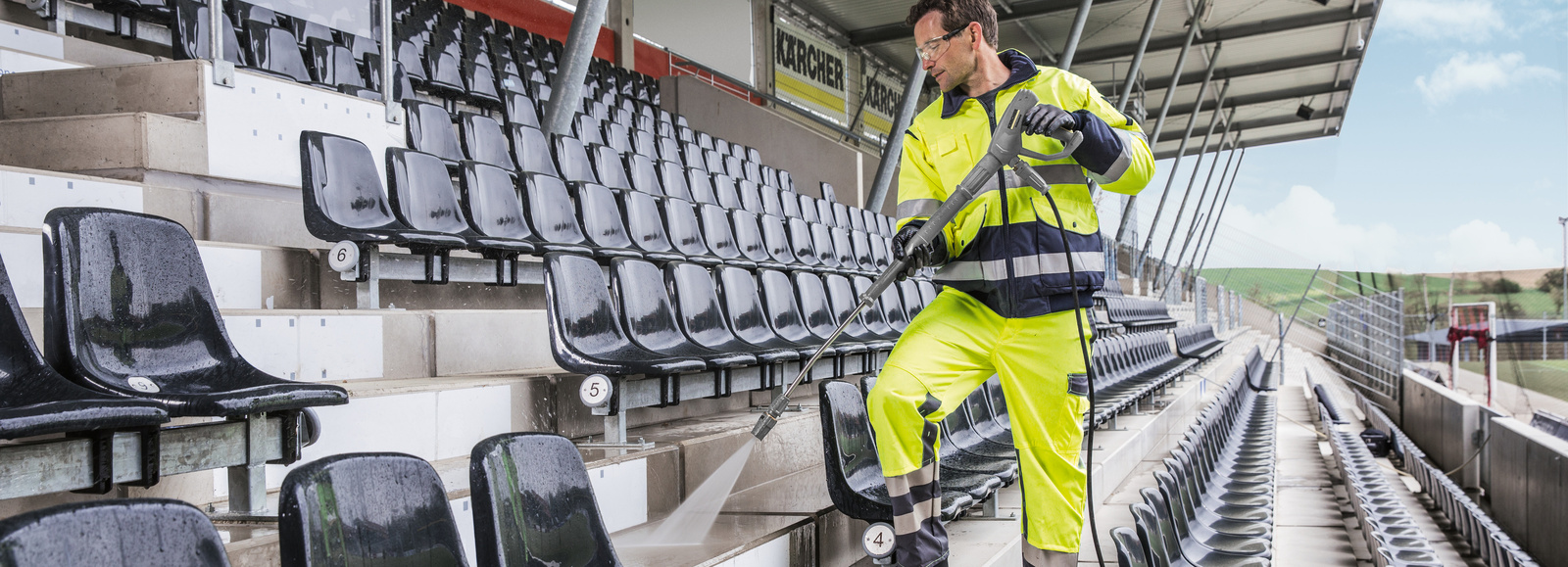High pressure cleaner in use A man cleaning a grandstand with a Kärcher high pressure cleaner