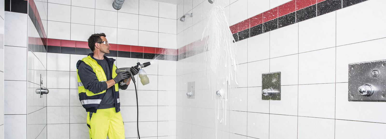 High pressure cleaner A man cleans a sanitary area with a Kärcher high-pressure cleaner