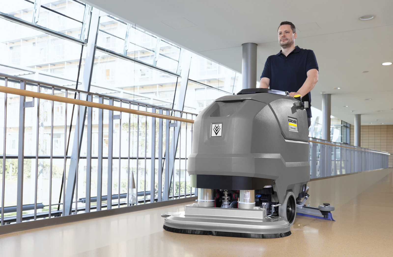 Cleaning the aisles A man is cleaning the floor of a senior care home with a scrubber dryer