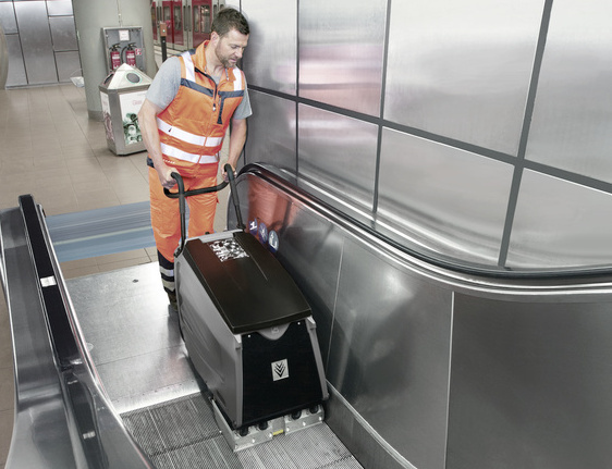 Escalator cleaner A man cleaning an escalator with an escalator cleaner