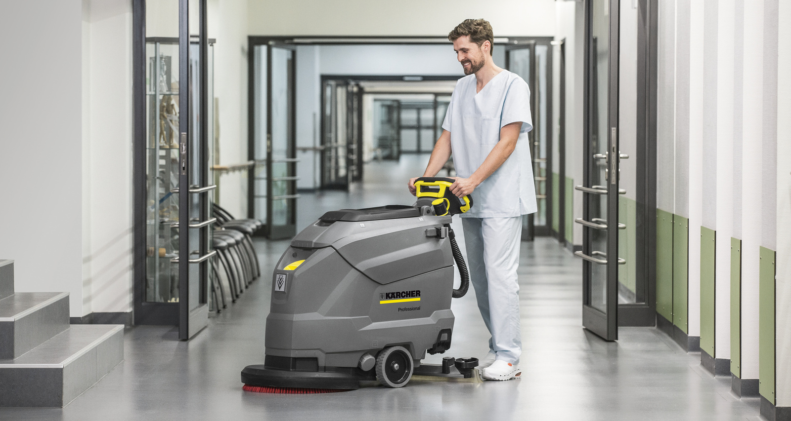 Cleaning with a walk-behind scrubber dryer The walk-behind scrubber dryer in use