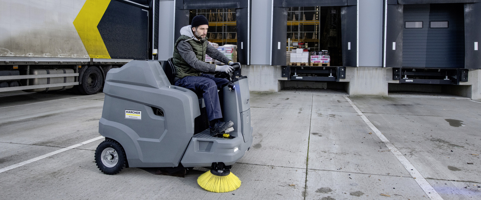 Ride-on vacuum sweeper in use Ride-on vacuum sweeper in use