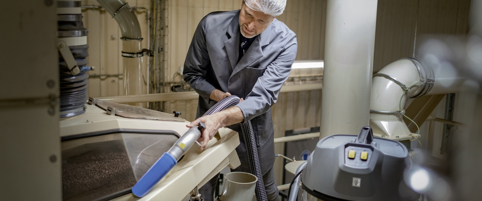 The liquid and swarf vacuum in action A man operates the liquid and swarf vacuum