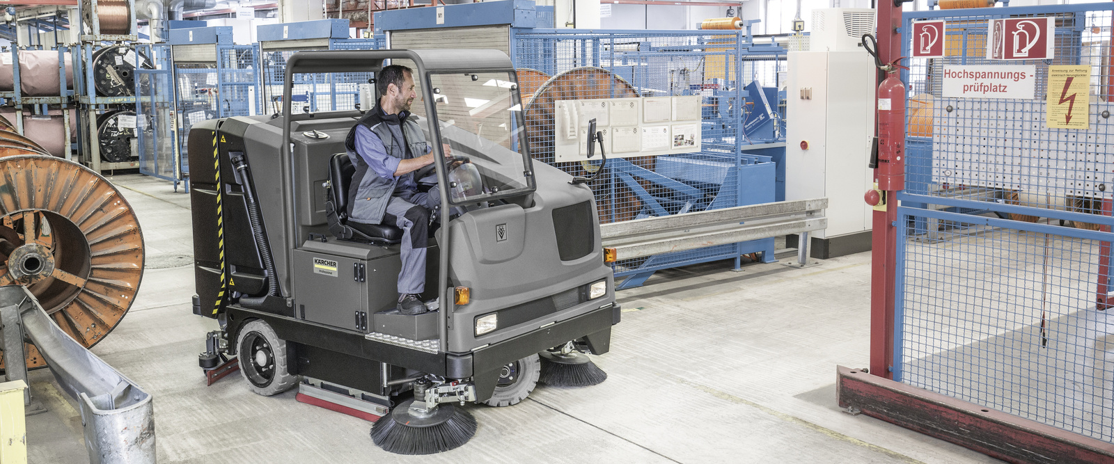 Industrial sweeper for efficient floor cleaning A person cleans the floor with the industrial sweeper
