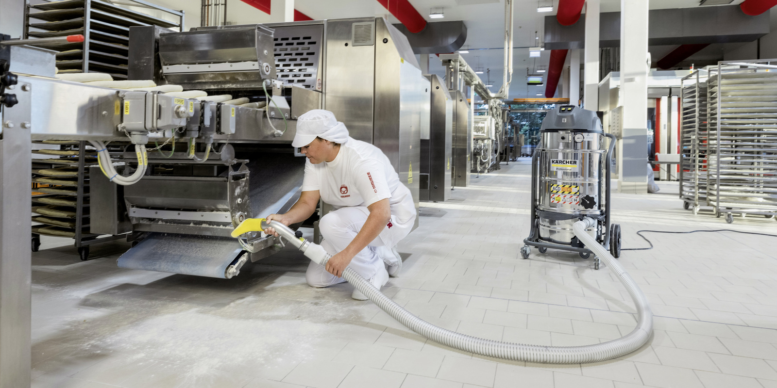 Industrial vacuum cleaner in use in the food industry A person uses a Kärcher industrial vacuum cleaner for cleaning in the food industry