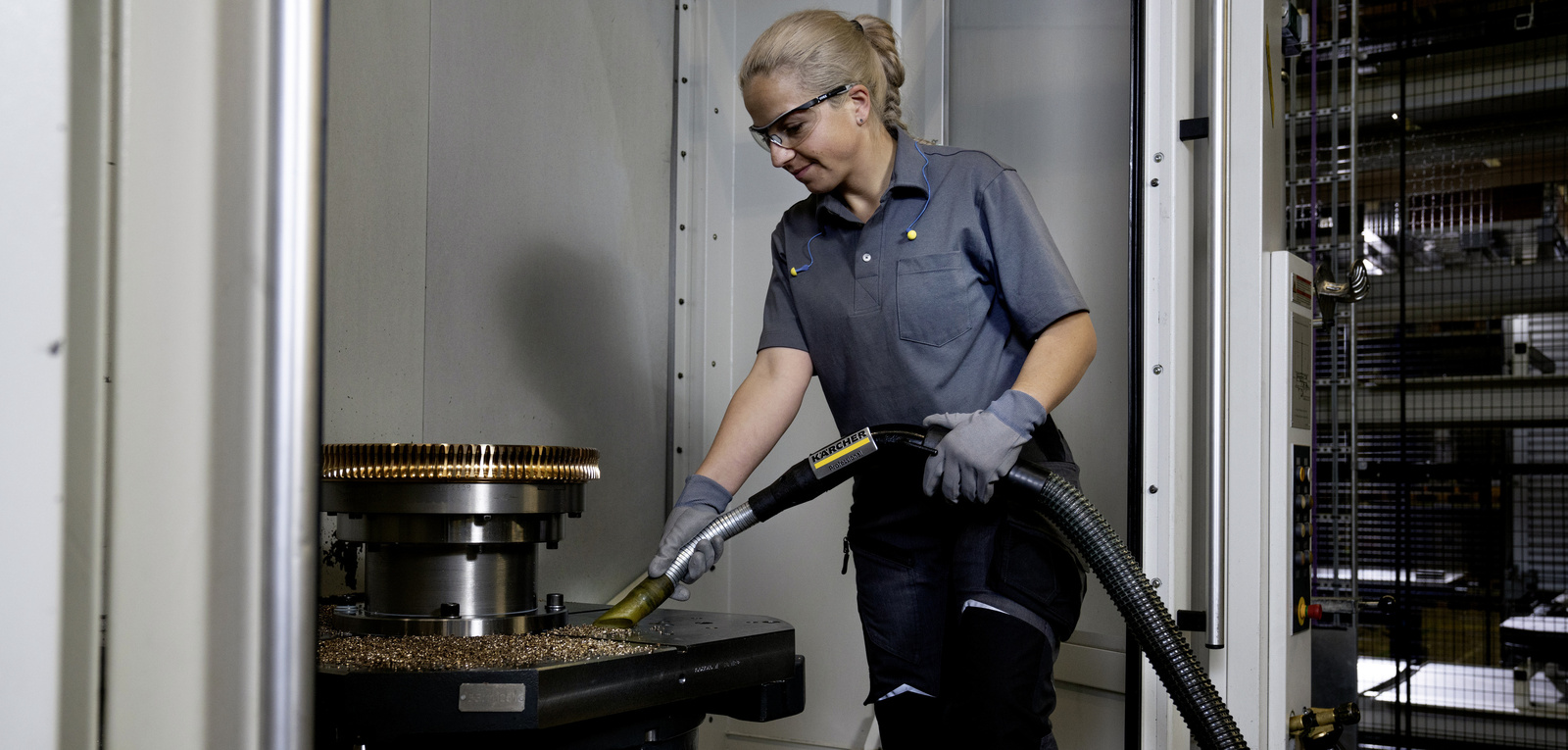 Extraction of metal chips with industrial vacuum cleaners A woman vacuums metal shavings with an industrial vacuum cleaner