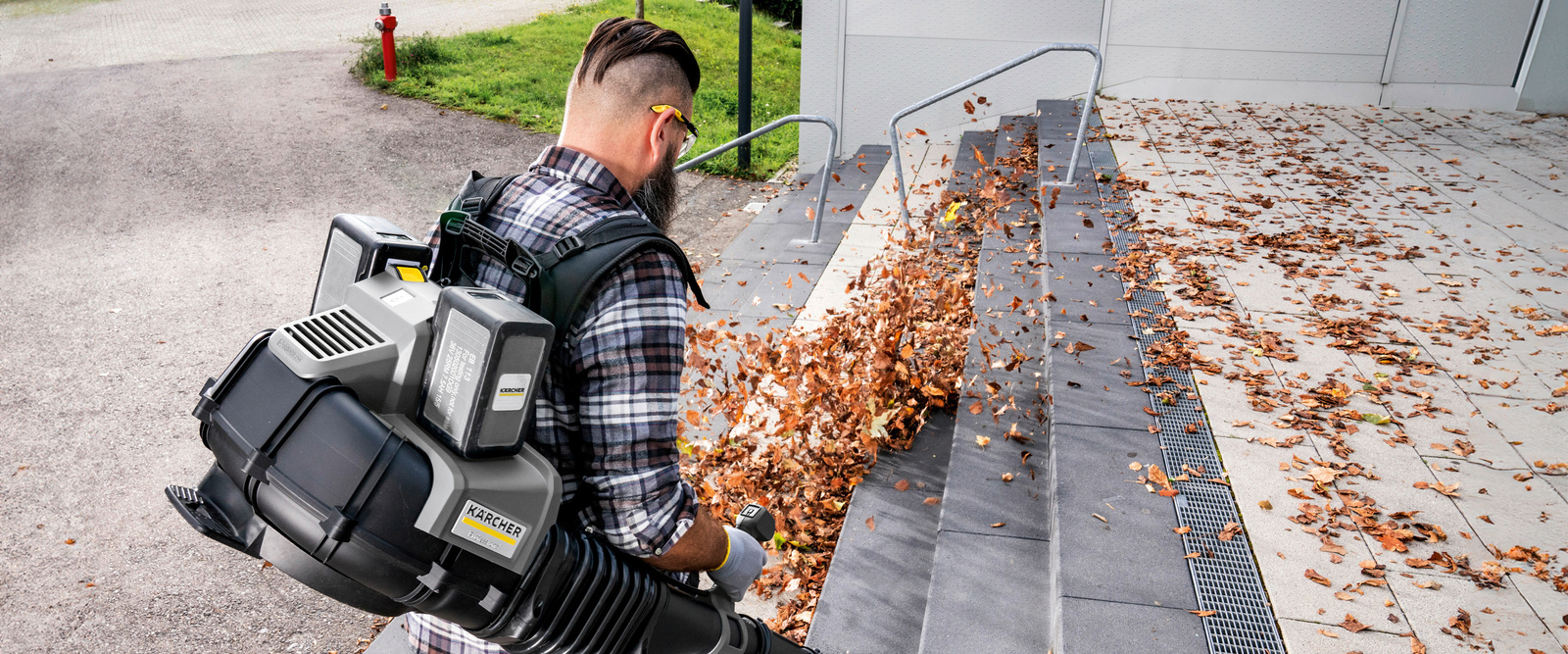 Leaf blower in use A person operating a Kärcher leaf blower