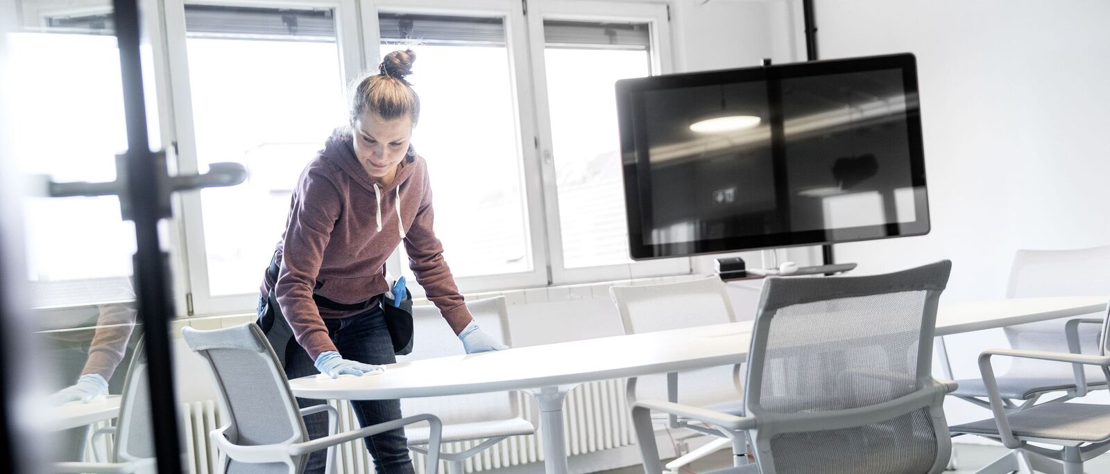 Daytime cleaning as an opportunity A woman cleaning a table