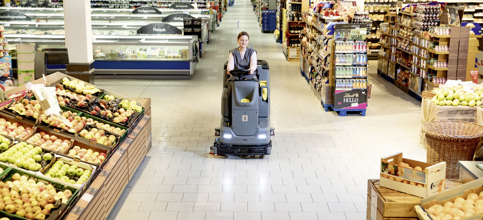 Scrubber dryer A person cleaning a grocery store with a scrubber dryer