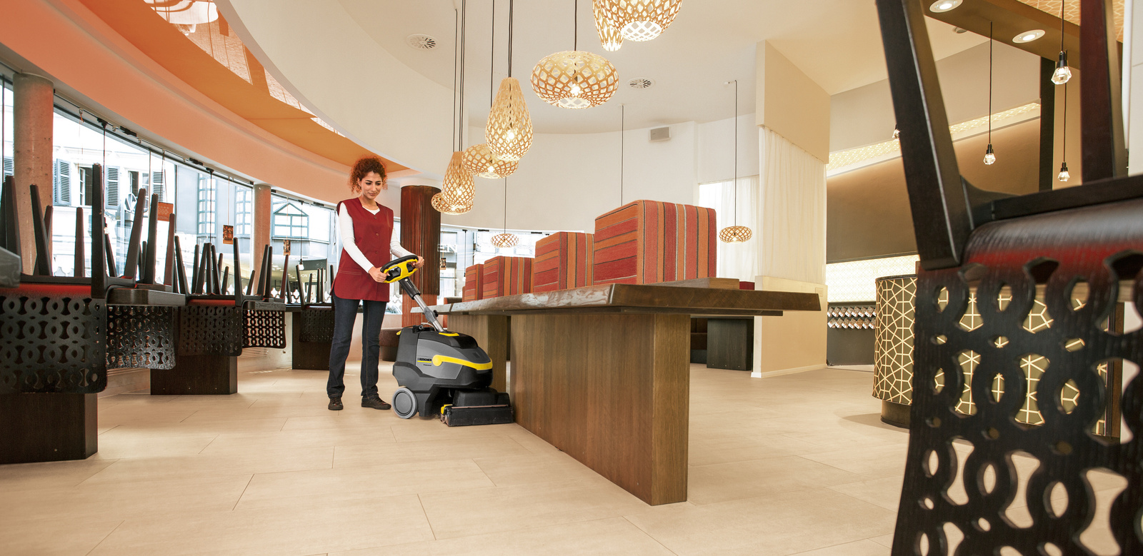 One person cleans the floor in the restaurant