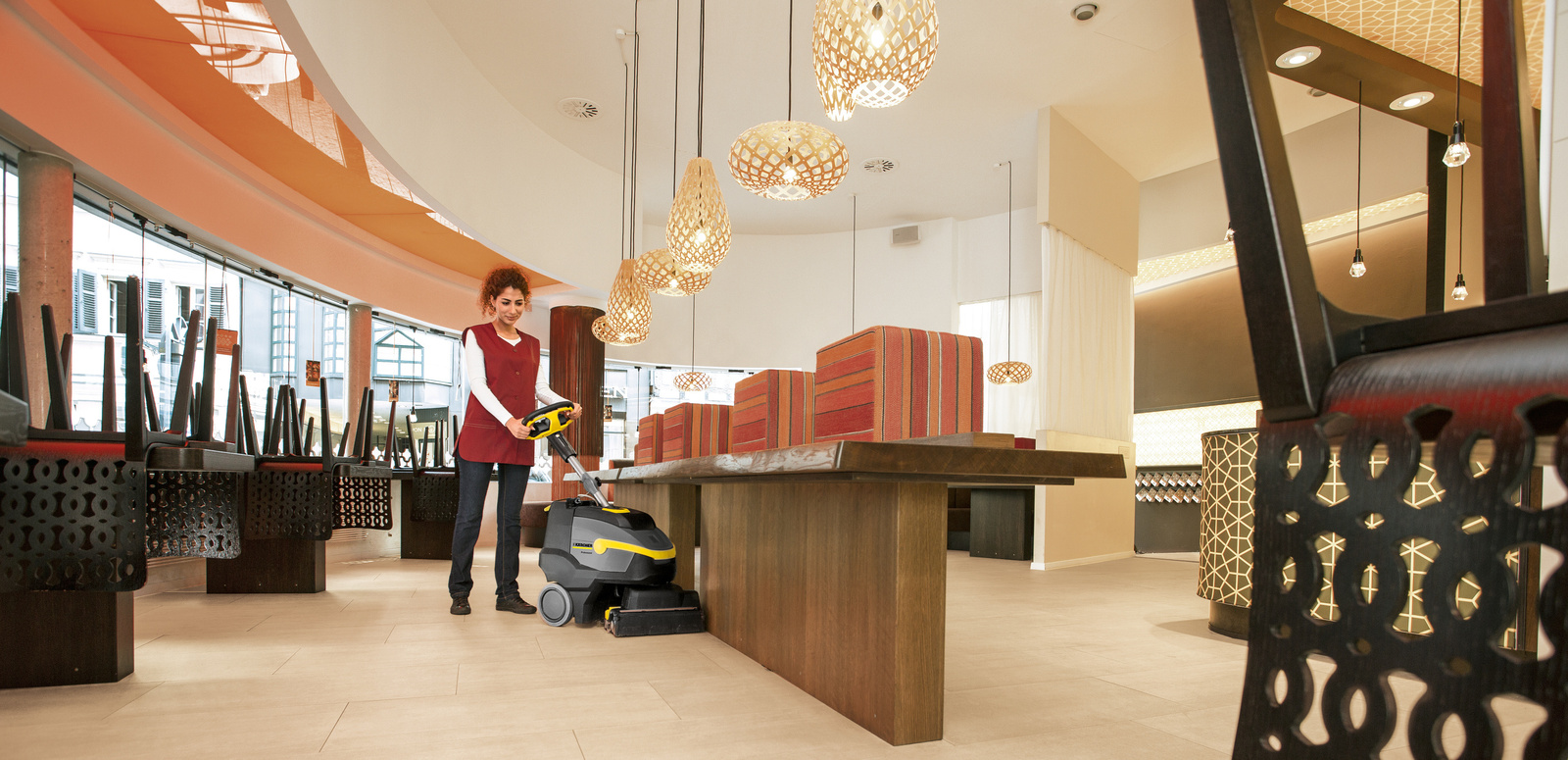 Cleaning restaurant A person cleaning the floor of a restaurant with a scrubber dryer