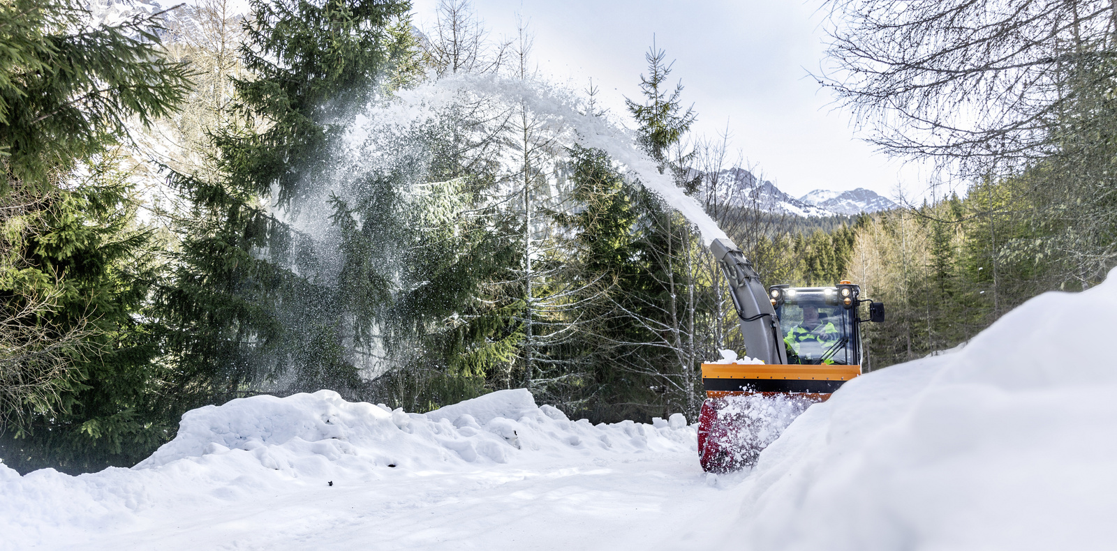 Winter services A snow blower clears a path of snow