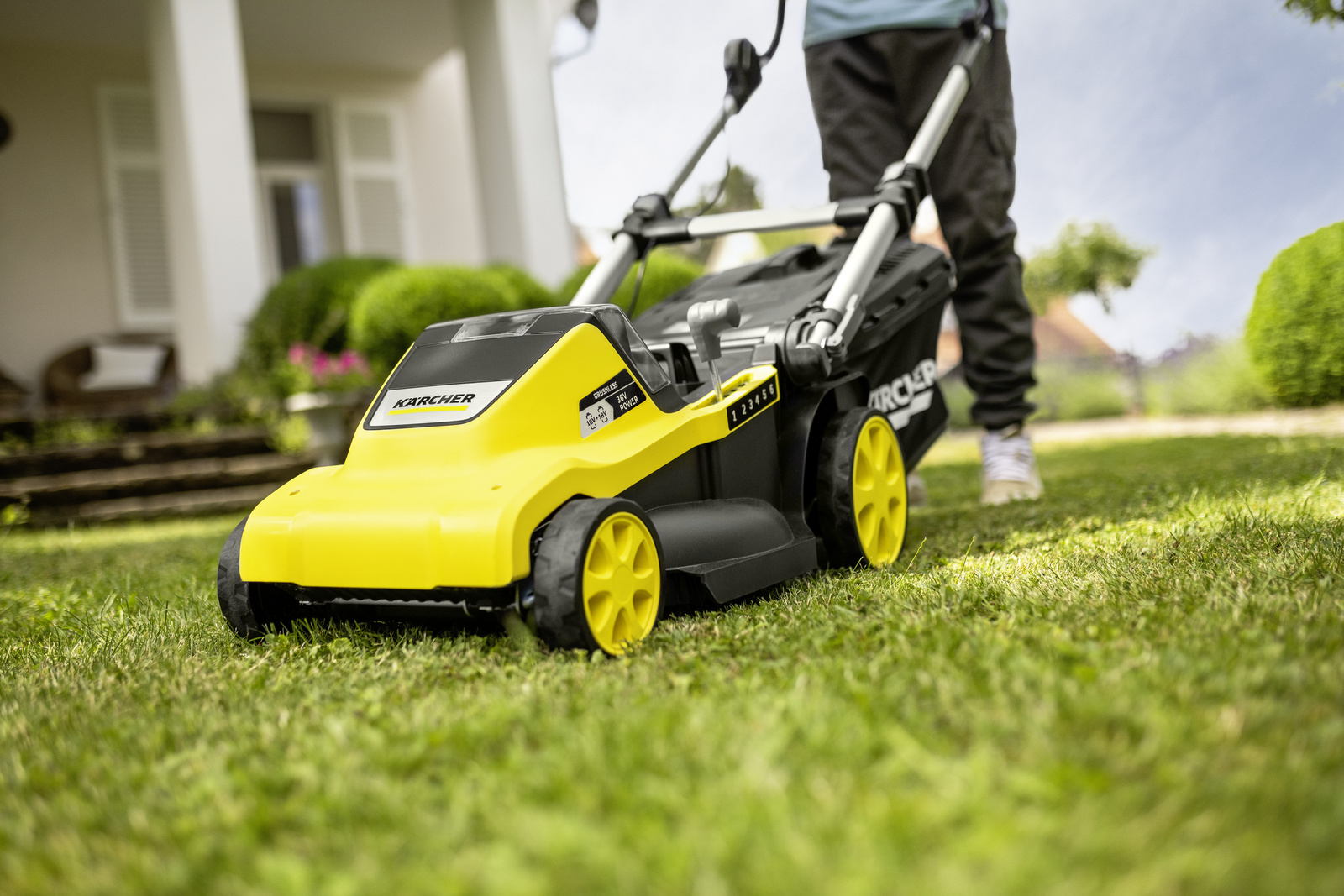 Mowing the lawn with a Kärcher lawn mower