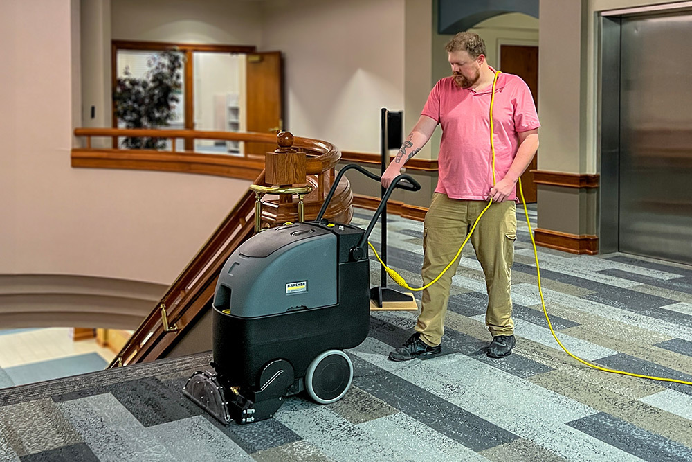 Compact Carpet Extractors A worker cleans carpets in a hotel