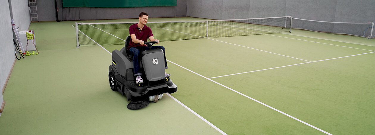 Kärcher scrubber dryer in a corridor Man seen cleaning a linoleum floor using a Kärcher scrubber dryer