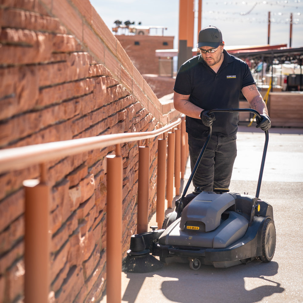 cleaning entrance with walk behind sweeper
