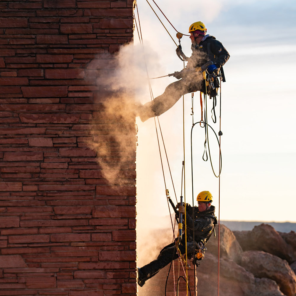 Pressure washing building façades.