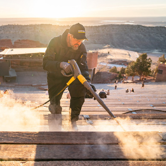 Pressure washing with the stage as a backdrop.