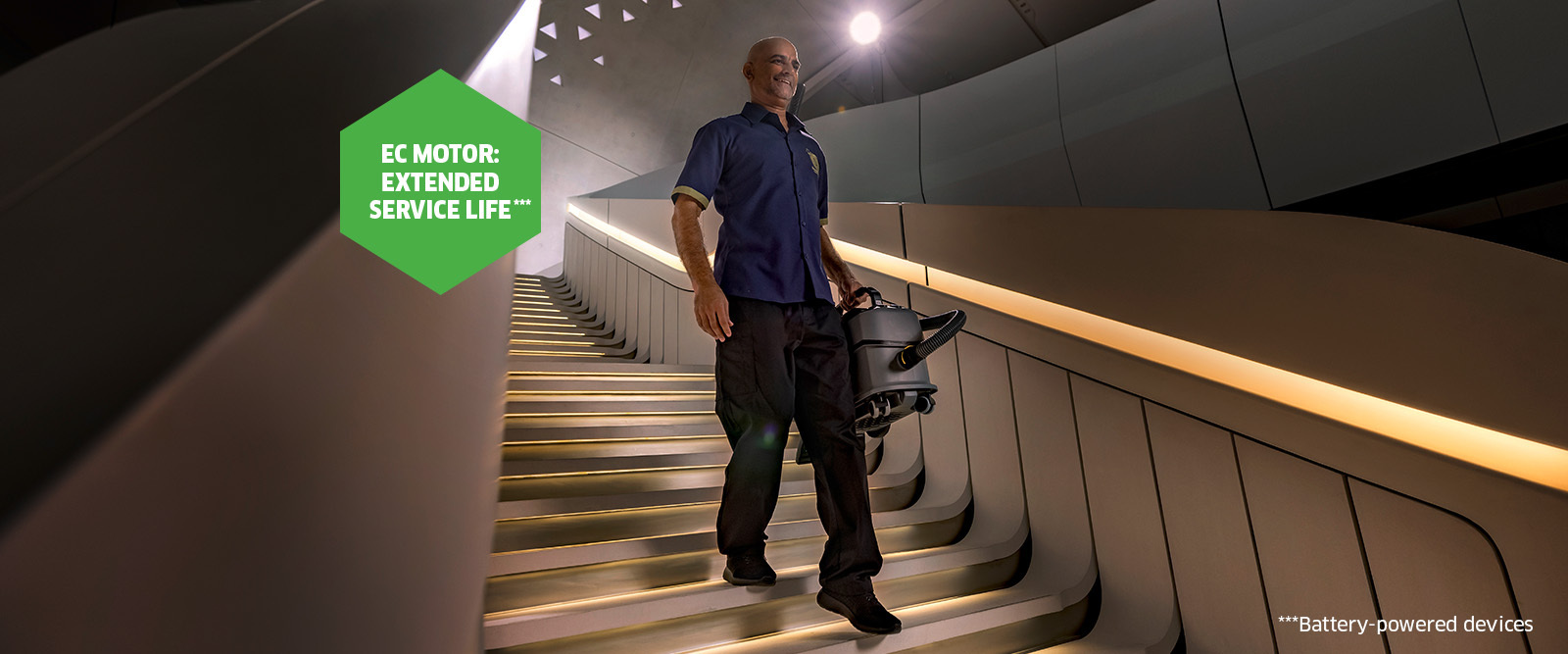 Dry vacuum cleaner being carried down the stairs Dry vacuum cleaner being carried down the stairs