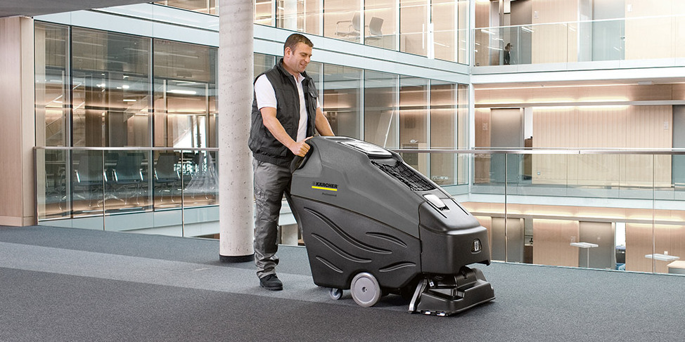 Extractors used in office buildings A worker cleans carpets in an office building with a Kärcher carpet extractor