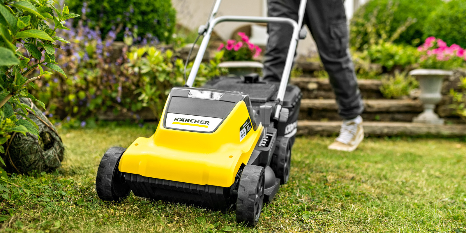 Woman preparing her Kärcher lawn mower