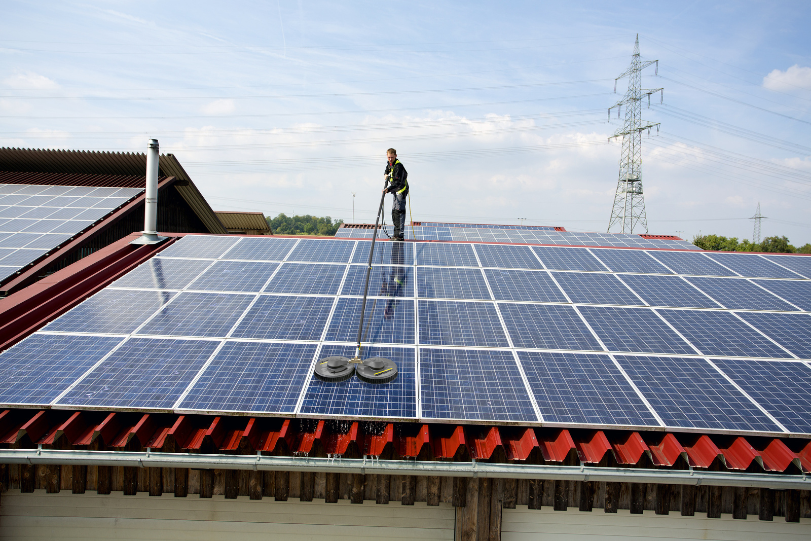 Image shows thr cleaning of solar systems on a roof
