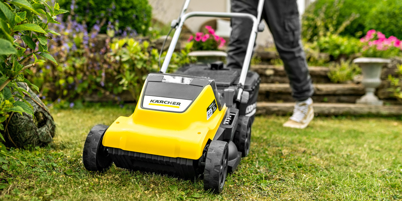 Woman preparing her Kärcher lawn mower