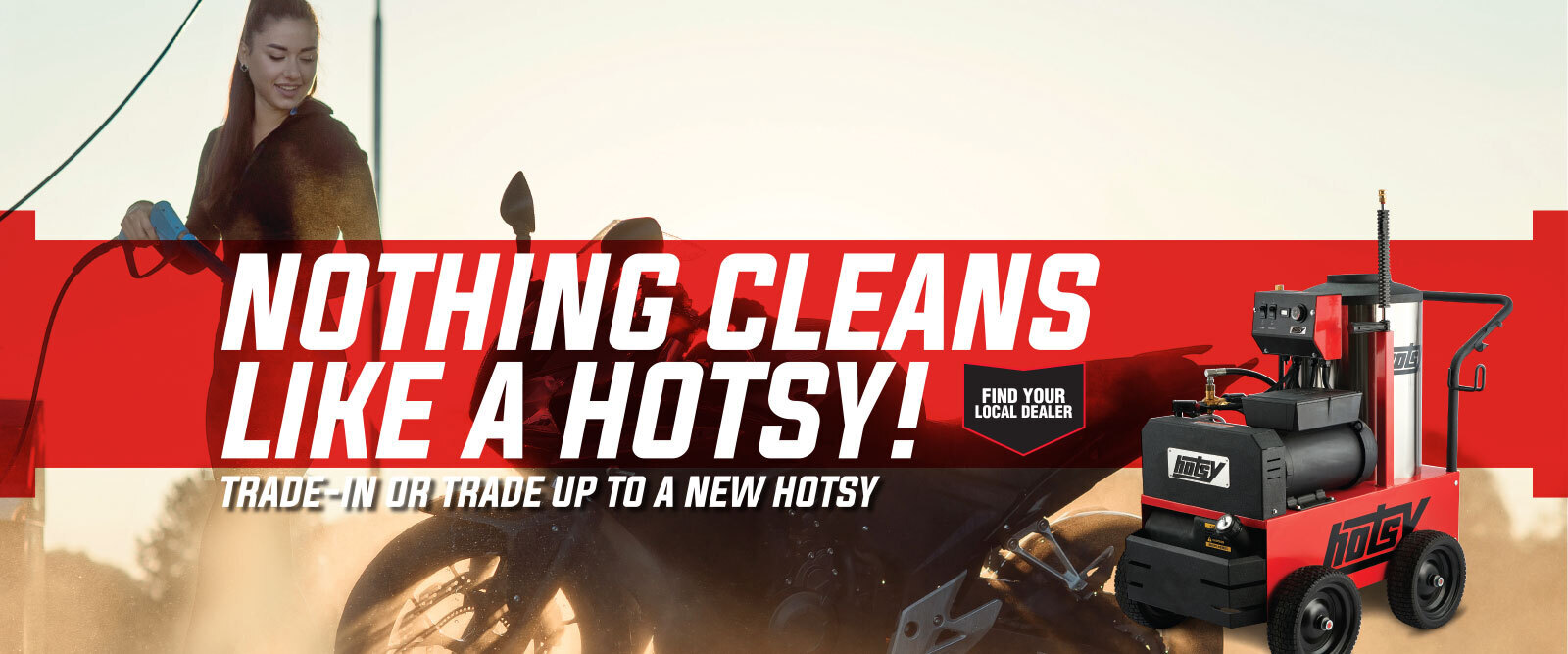 A woman pressure washes a motorcycle