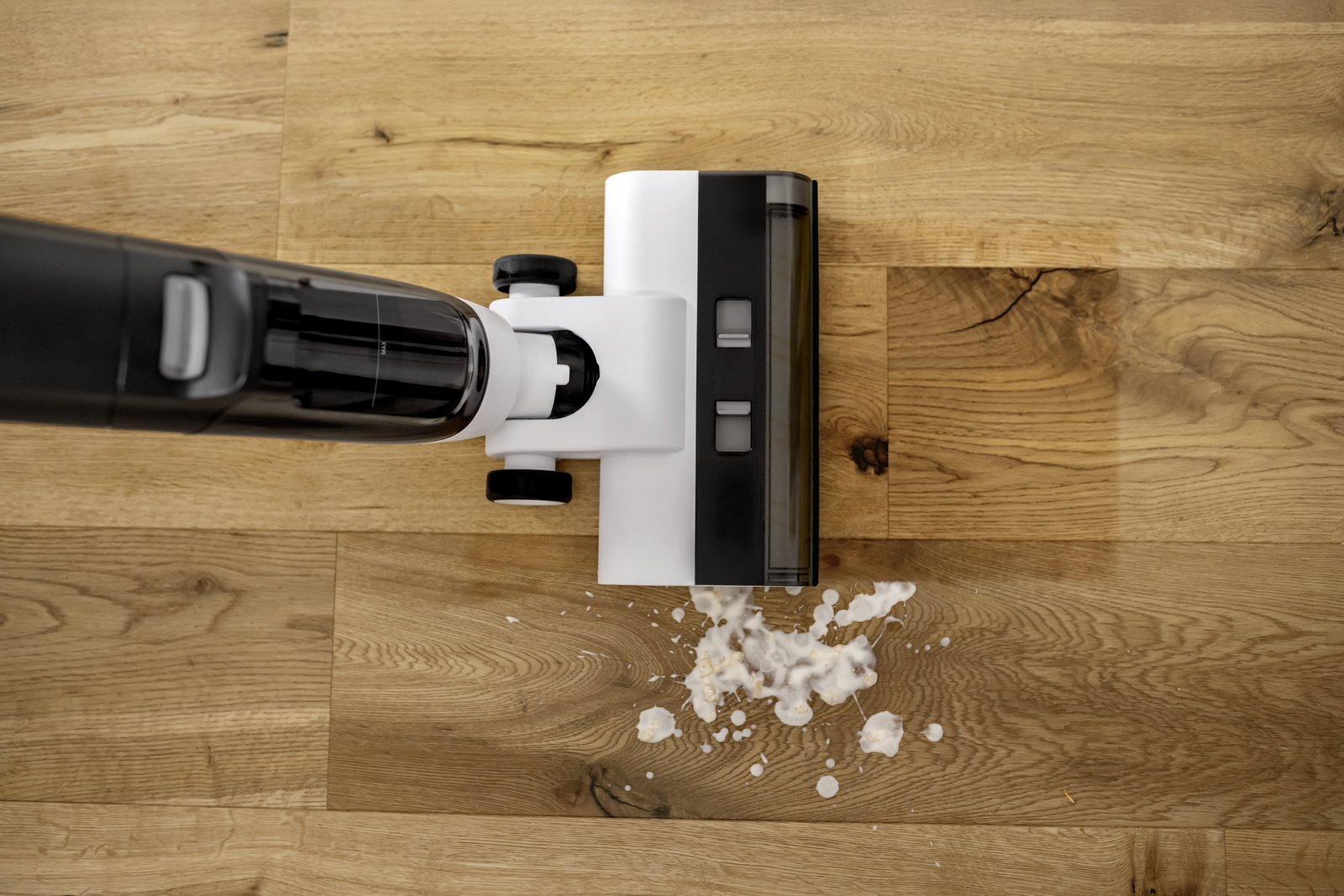 A man removes moss on a wall with a Kärcher pressure washer