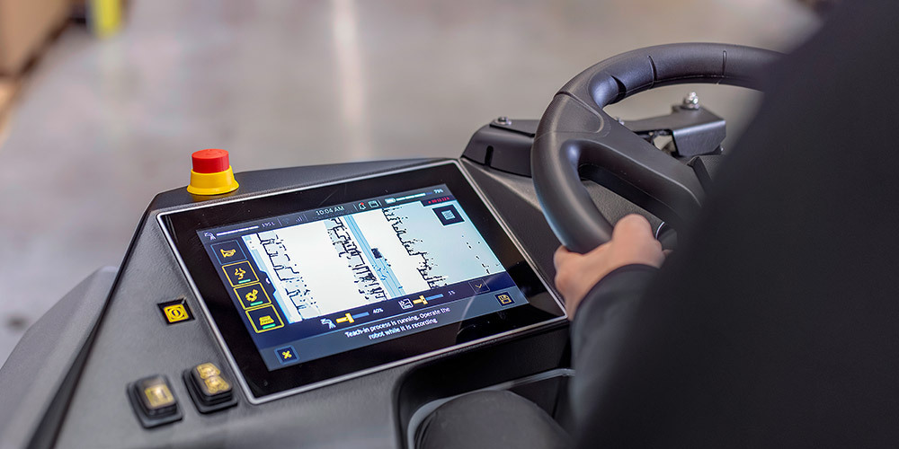 Overhead view of the B200 steering wheel with touchscreen and switches on dashboard