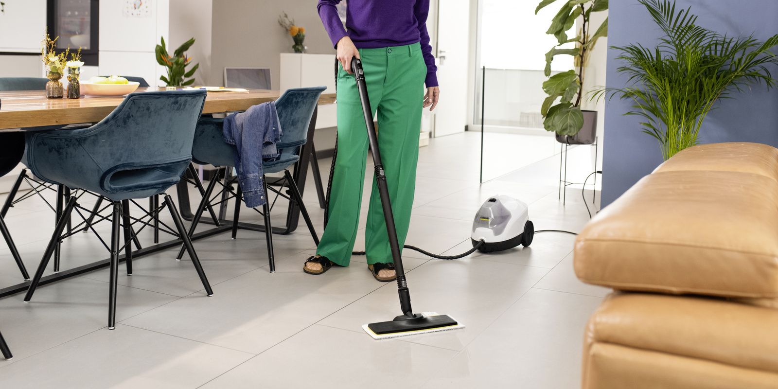 Woman ironing with steam cleaner with steam pressure iron