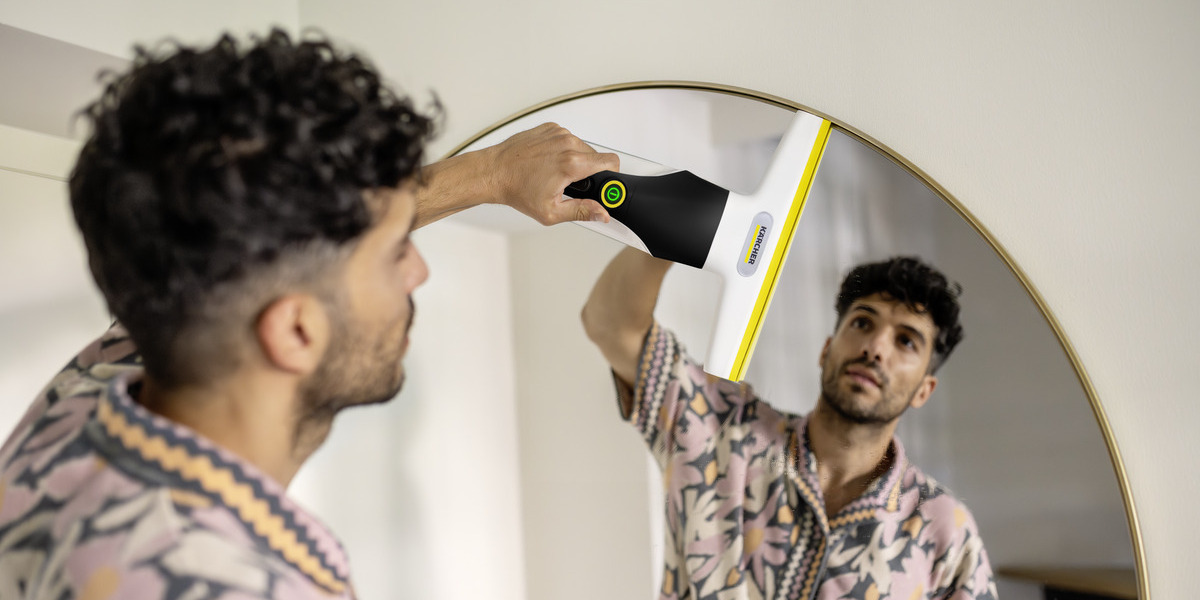 Person cleaning floor using Kärcher steam cleaner