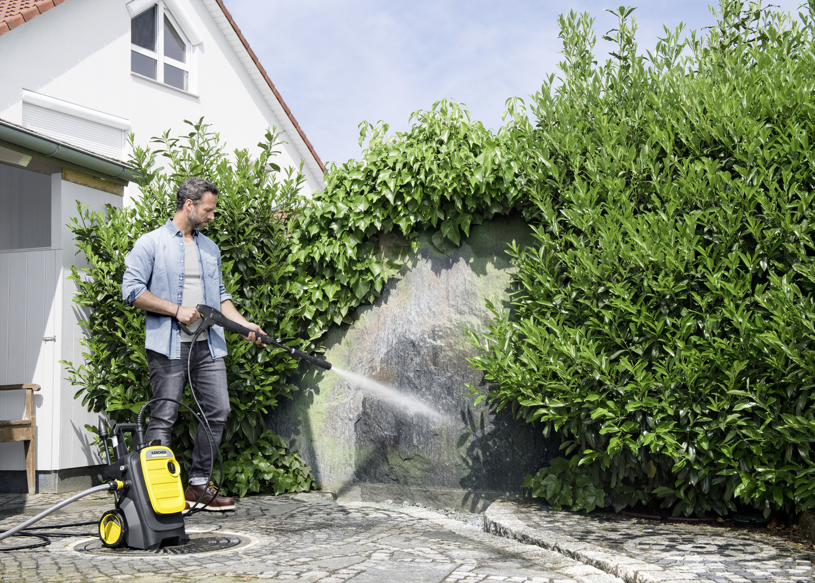 Person cleaning floor with Power Control trigger gun