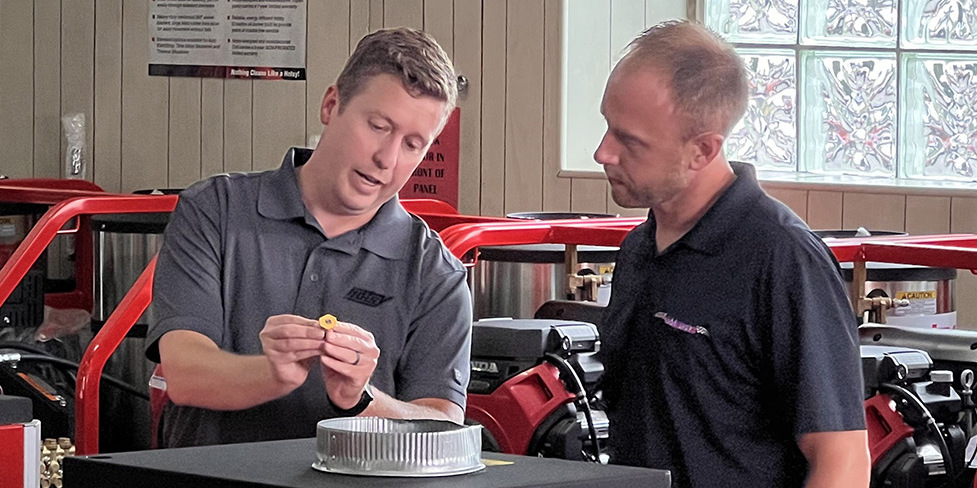 A Hotsy dealer helps a customer in a dealer's showroom.