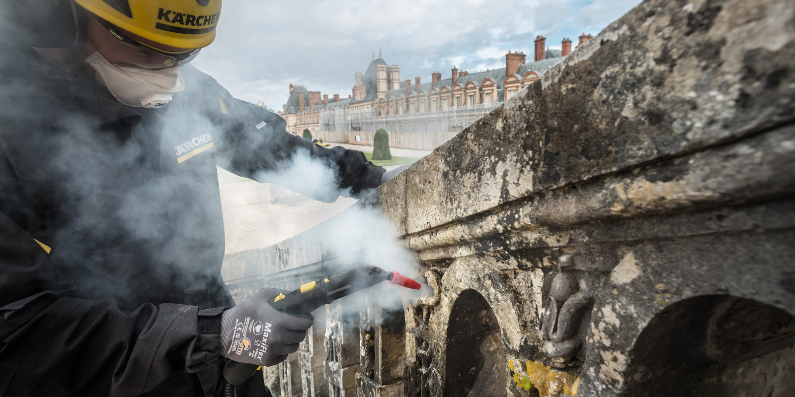 Kärcher worker uses a small steamer Kärcher worker cleans with a small steamer at the Palace of Fontainebleau